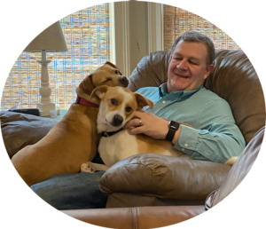 Photograph of Richard, the founder with his two rescue dogs.
